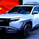 Китайський електромобіль на тлі прапора Китаю на презентації