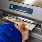Рука виймає євро з банкомата ВТБ під час обмежень зняття готівки в Криму