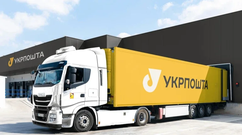 Біло-жовта вантажівка Укрпошти біля логістичного центру компанії